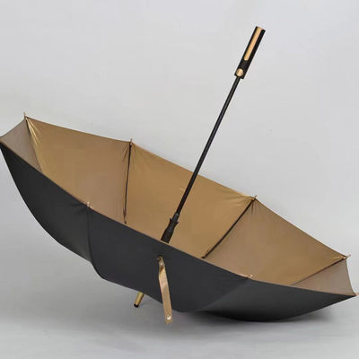 Paraguas de tela recubierta de oro con control semiautomático y mango dorado
